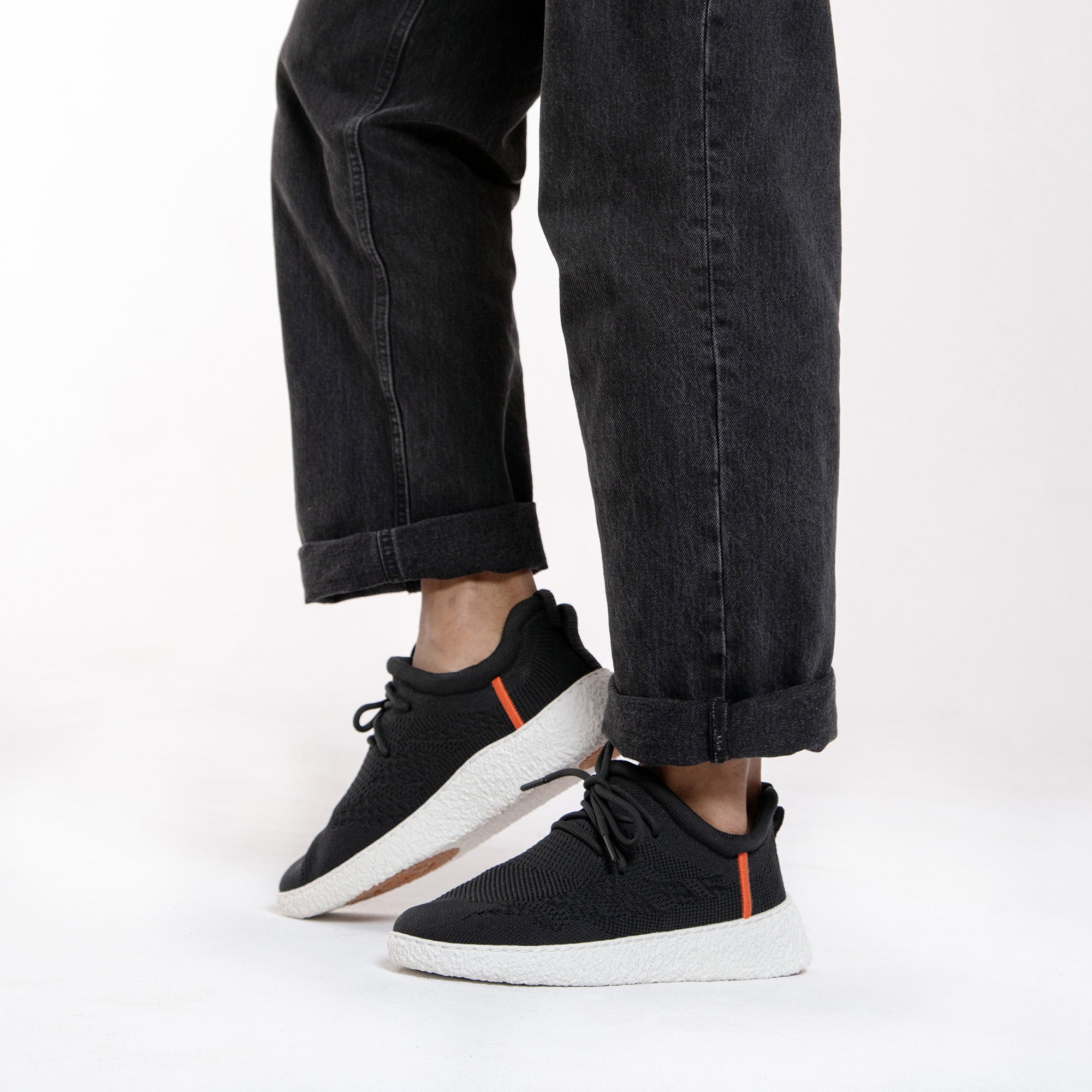 Baliston shoes on person wearing black jeans.